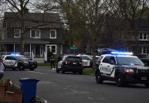Shocking Kitchen Killing Shakes Quiet Suburb Police SUVs with lights on block a suburban street