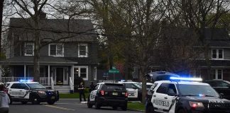 Shocking Kitchen Killing Shakes Quiet Suburb Police SUVs with lights on block a suburban street