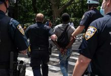Gang Kidnapping Ends With 3 Men in Prison Police escort a handcuffed man across a city street