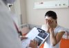 Judge Trusted Doctor – Then The Knives Came Out Woman covering her face while doctor holds a clipboard in a hospital room