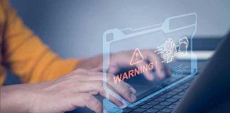 Woman’s AI Conversation Triggers Criminal Investigation Hands typing on laptop with digital warning alert overlay