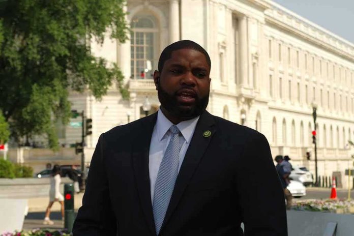 Man in a suit speaking outside a neoclassical government building
