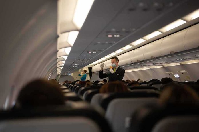 shutterstock_2341255709 Flight attendant demonstrates safety procedures in airplane cabin