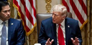 Gold Trump Sparks Fury In Strasbourg Donald Trump speaks at a meeting table beside Marco Rubio
