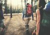 hikers walking through a sunlit forest