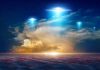 Glowing lights above dramatic sunset clouds