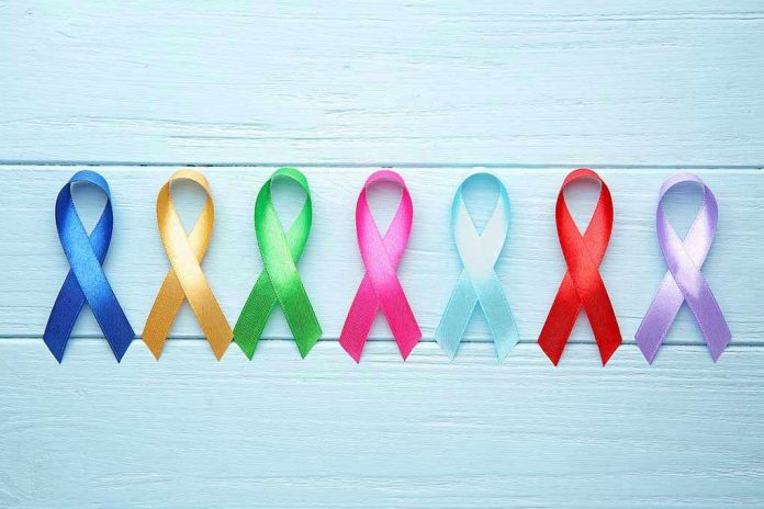 1564226551 Colorful awareness ribbons on light wooden background