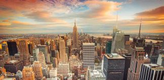 New York City skyline at sunset with tall buildings.