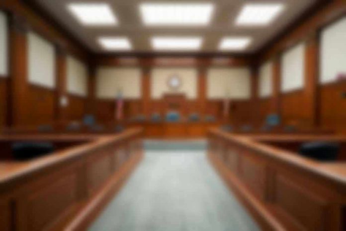 2324977165 Empty courthouse courtroom with wooden benches and chairs.