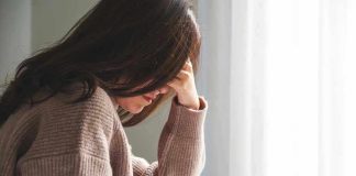 Person with head down, looking distressed or contemplative.