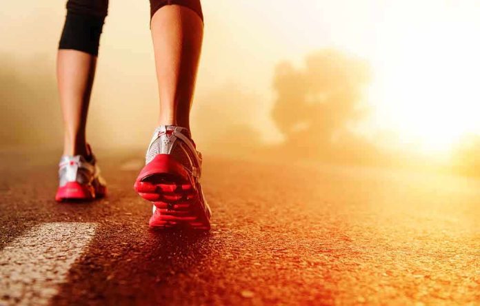 shutterstock_106892909.jpg Person jogging on a road during sunrise