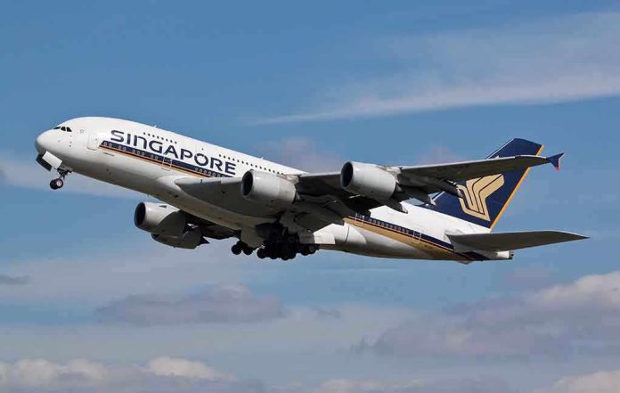 shutterstock_187642727.jpg Singapore Airlines airplane taking off against a blue sky