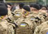 Soldiers in camouflage uniforms with Ukrainian flags
