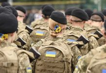 Soldiers in camouflage uniforms with Ukrainian flags