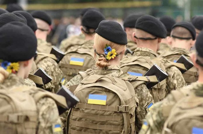 2029545419 Soldiers in camouflage uniforms with Ukrainian flags