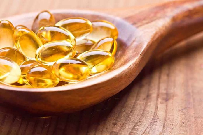 shutterstock_175262174.jpg Golden omega 3 capsules in a wooden spoon