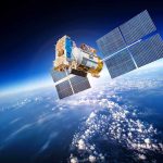 A satellite equipped with solar panels orbiting above the Earth